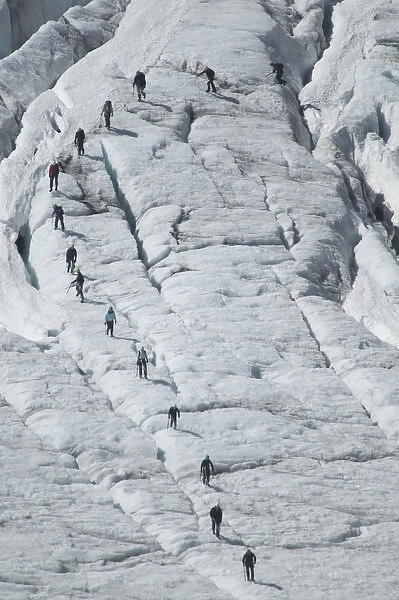 Glacier hikers wind through the blue ice crevices and over snow fields of Folgefonna Glacier