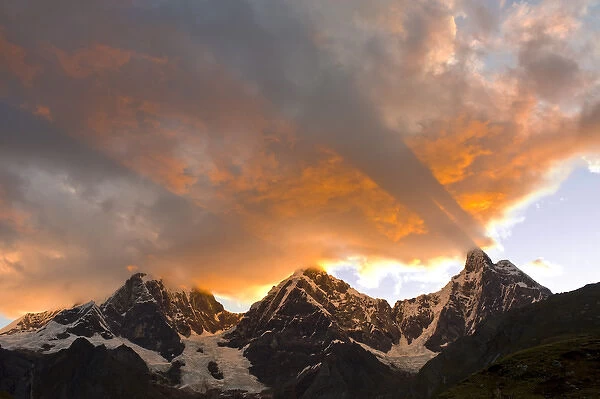 God rays, Crepuscular rays, clouds, and mountain peaks at sunset, Yerupaja, Grande and Chico to left
