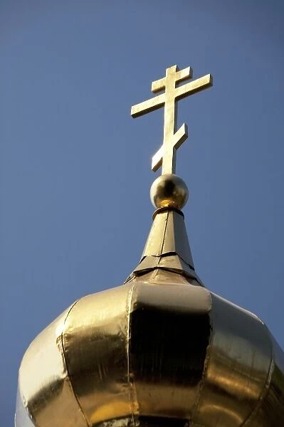 Golden cross of the Russian Orthodox Church on golden dome of Church of the Archangel