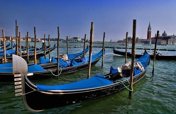 Grand Canal water with gondalo boats lined up for use in romantic city of Venice