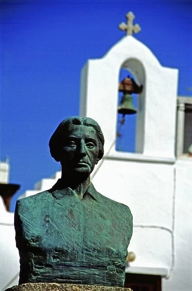 Greece, Aegean Sea, Mykonos. Female statue in front of typical white church bell tower