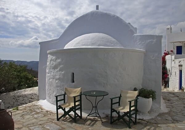 Greece, Amorgos, Chora. A cafe expands to a neighboring Greek Orthodox church