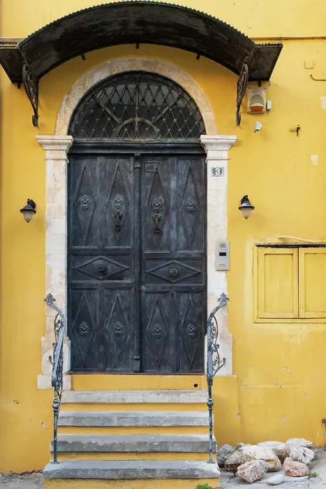 Framed Print : Greece, Crete, Chania, Old Town. Black double doorway in yellow wall