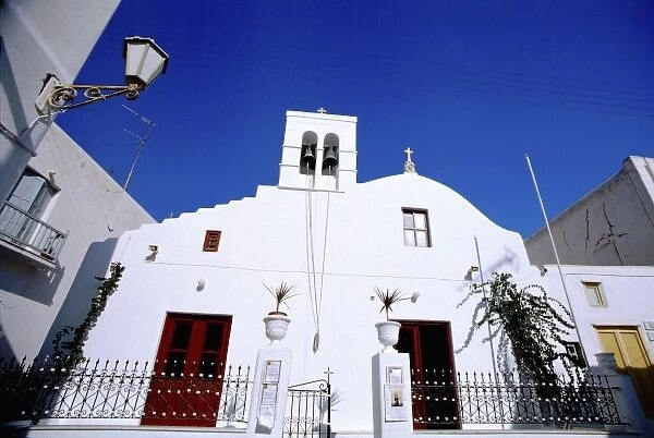 Greece, EU, Aegean Sea, Mykonos. Typical street scene, white church