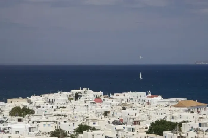 Framed Print : Greece, Mykonos, Hora. Overlook of town of and sailboat on ocean