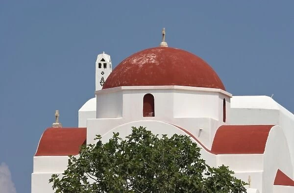 Greece, Mykonos, Hora. Red church dome and white walls against blue sky