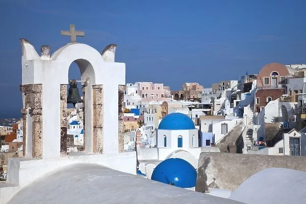 Greece, Santorini. Bell tower and blue domes of church in village of Oia