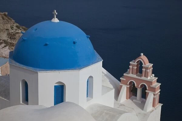 Greece, Santorini. Bell tower and blue domes of church in village of Oia