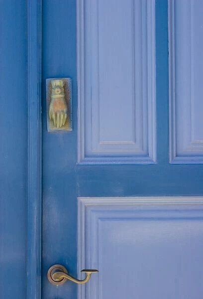 Greece, Santorini. Blue door with knocker in the shape of a hand