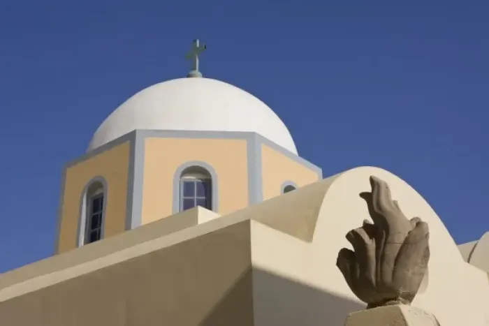 Framed Print : Greece, Santorini. Church dome against blue sky with small sculpture in foreground