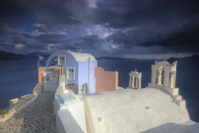 Framed Print : Greece, Santorini, Evening light in Oia town with bell towers and colorful building on point Framed Print : Greece, Santorini, Evening light in Oia town with bell towers and colorful building on point