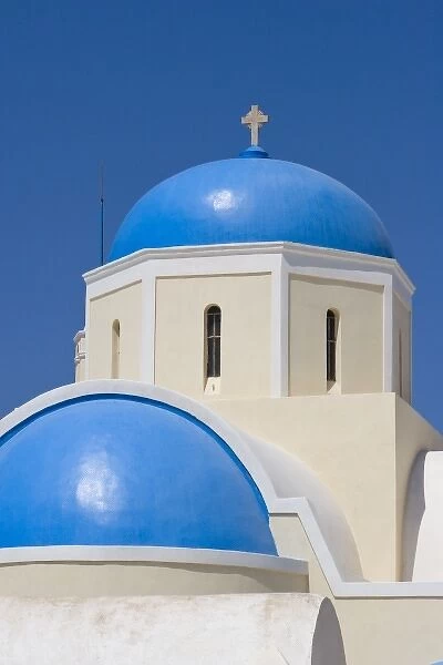 Greece, Santorini, Thira, Oia. Blue Greek Orthodox church domes against blue sky