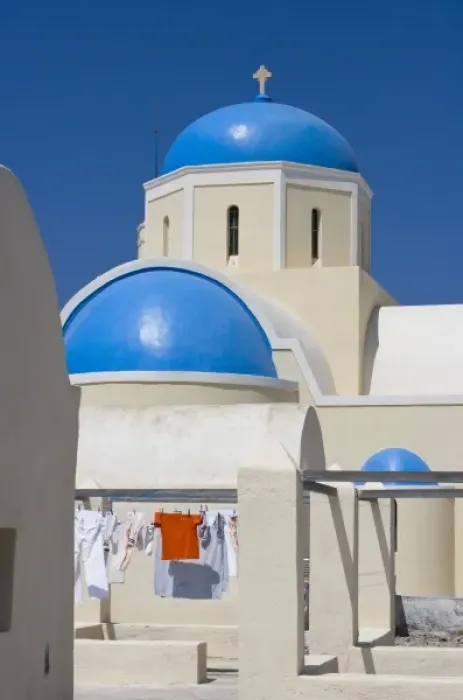 Framed Print : Greece, Santorini, Thira, Oia. Blue Greek Orthodox church domes contrast with drying laundry Framed Print : Greece, Santorini, Thira, Oia. Blue Greek Orthodox church domes contrast with drying laundry