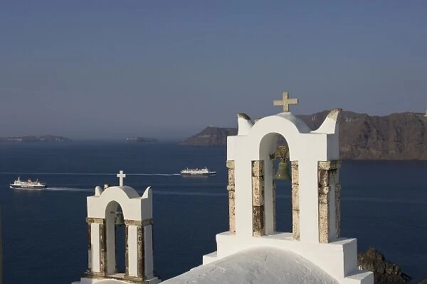 Greece, Santorini, Thira, Oia. Two Greek Orthodox church bell towers and two Hellenic