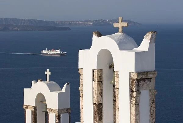 Greece, Santorini, Thira, Oia. Two Greek Orthodox church bell towers and a Hellenic