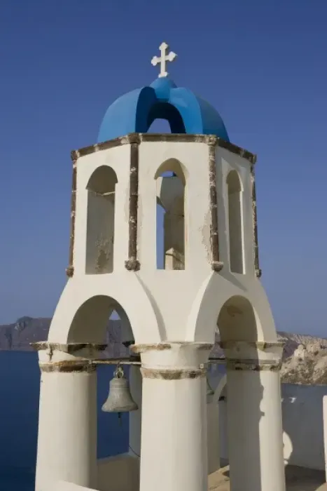 Framed Print : Greece, Santorini, Thira, Oia. Greek Orthodox church bell tower with cross overlooking sea