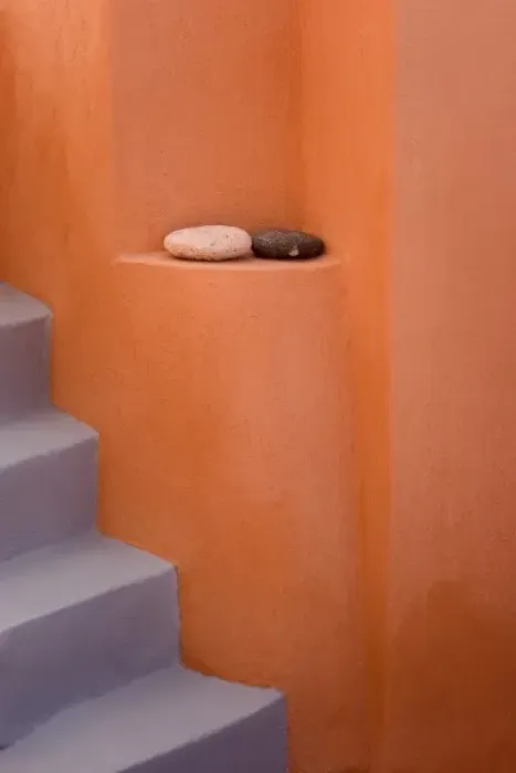 Framed Print : Greece, Santorini, Thira, Oia. Grey stairs contrast with orange wall and two rocks on ledge Framed Print : Greece, Santorini, Thira, Oia. Grey stairs contrast with orange wall and two rocks on ledge