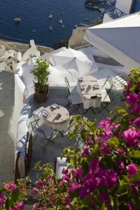 Framed Print : Greece, Santorini, Thira, Oia. Looking down on patio tables set for dinner Framed Print : Greece, Santorini, Thira, Oia. Looking down on patio tables set for dinner