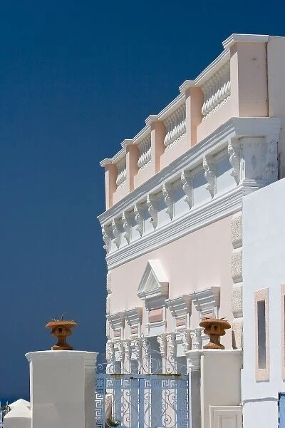 Greece, Santorini, Thira, Oia. Ornate pink villa facade against clear blue sky