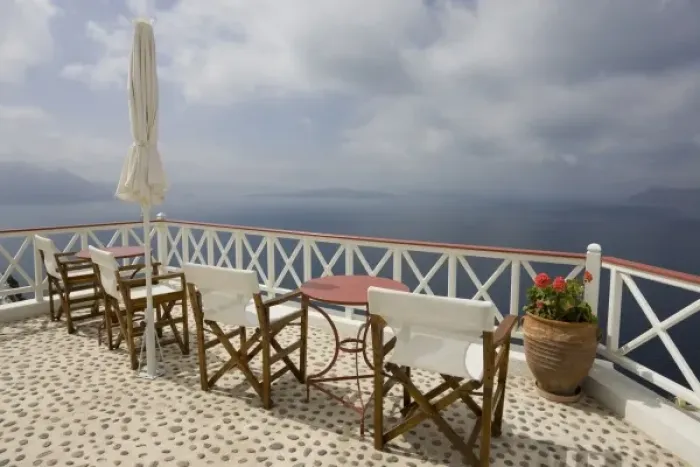 Framed Print : Greece, Santorini, Thira, Oia. Patio tables and chairs on pebbled deck overlooking misty sea Framed Print : Greece, Santorini, Thira, Oia. Patio tables and chairs on pebbled deck overlooking misty sea