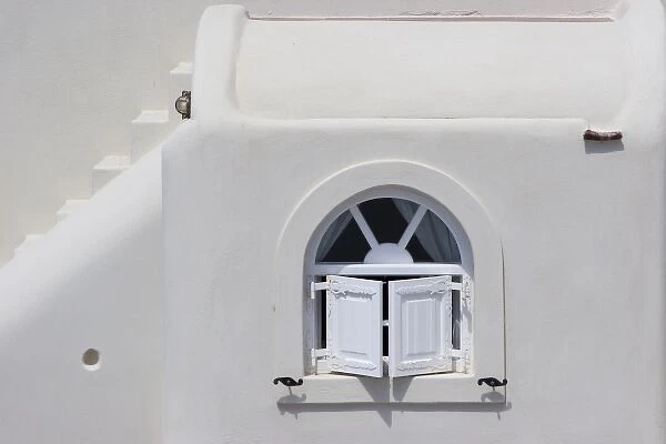 Greece, Santorini, Thira, Oia. White shuttered window in white wall and white stairs
