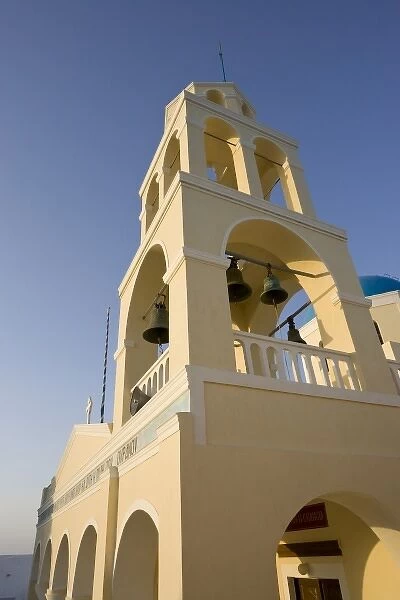Greece, Santorini, Thira, Oia. Yellow facade and bell tower of Greek Orthodox church