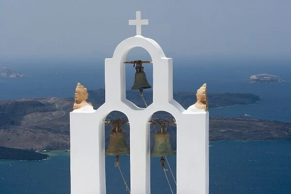 Greece, Santorini. White church bell tower with sea in background