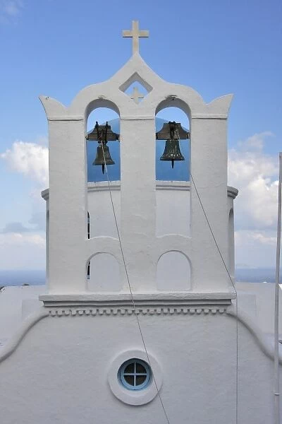 Greece, Sifnos, Apollonia. A traditional Cycladic bell tower in front of Greek Orthodox