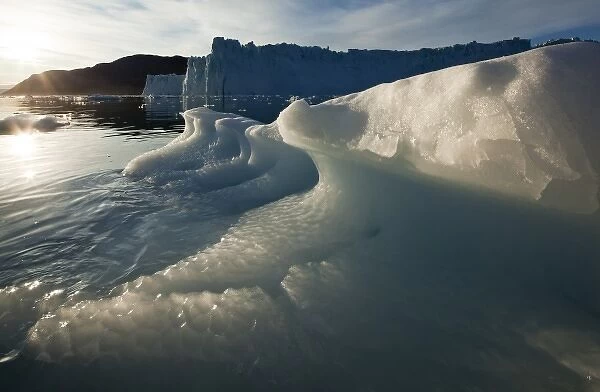 Greenland, Ilulissat, Icebergs near face of Eqip Glacier along Disko Bay lit by midnight