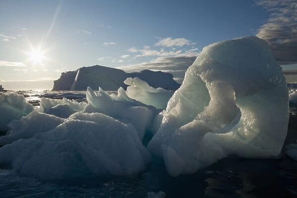 Greenland, Ilulissat, Midnight sun lights icebergs calved from Jakobshavn Glacier