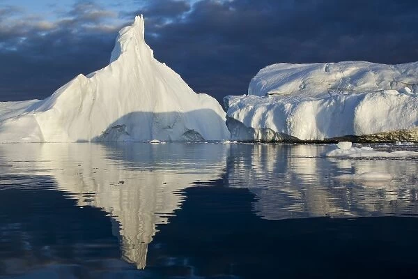 Greenland, Ilulissat, Midnight sun lights iceberg calved from Jakobshavn Glacier