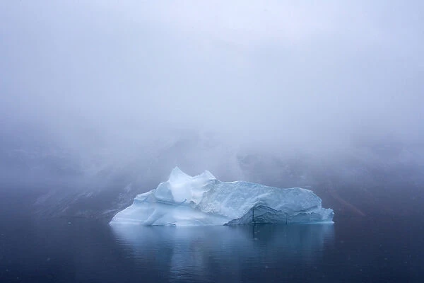 Greenland. Northeast Greenland National Park. Kong Oscar Fjord. Iceberg in dense fog