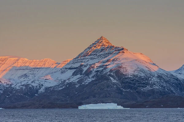 Greenland. Scoresby Sund. Gasefjord (Gooseford) Alpenglow on the mountain with iceberg