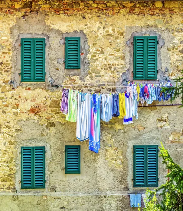 Framed Print : Greve in Chianti, Tuscany, Italy. View of family laundry hanging against a stone wall with green shuttered windows in an ancient town Framed Print : Greve in Chianti, Tuscany, Italy. View of family laundry hanging against a stone wall with green shuttered windows in an ancient town