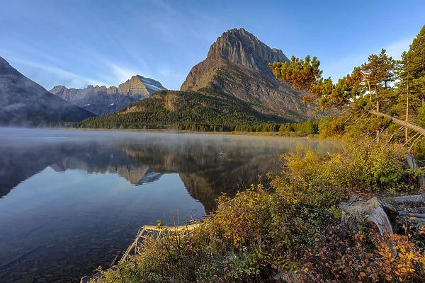 Grinnell Point and Mt. Gould reflection into Swiftcurrent Lake in early autumn in