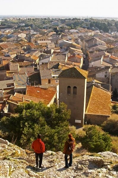 Gruissan village. La Clape. Languedoc. Village roof tops with tiles. A tourist couple