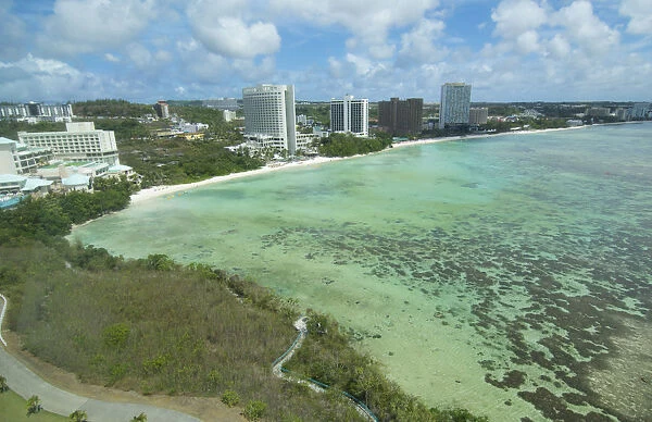 Guam USA Territory Tumon Bay hotels and beach from above with ocean beach and clouds