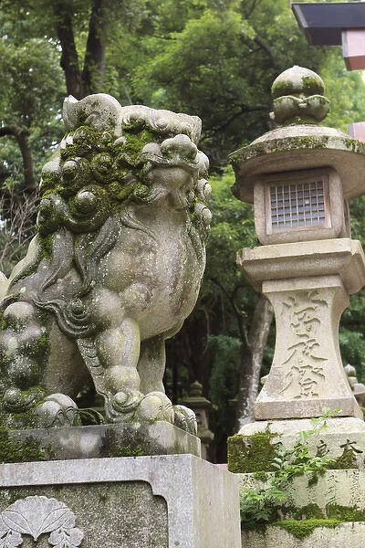 A guardian stone lion traditional stone lantern at the entrance to Kasuga-Taisha Shrine in Nara