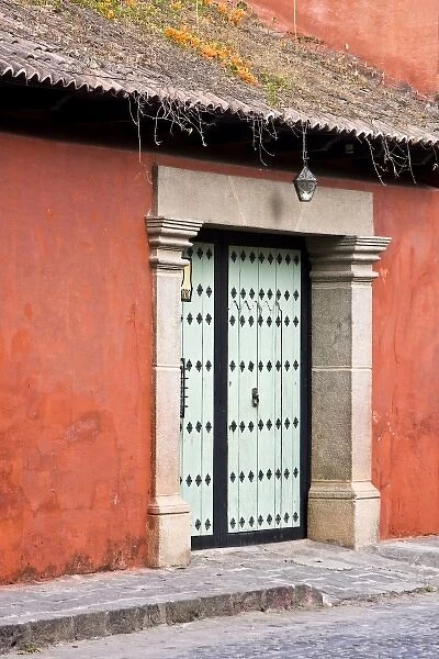 Guatemala, Antigua. A colonial house with ornate door in the town of Antigua
