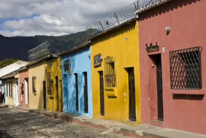 Framed Print : Guatemala, Antigua. Colorful houses along the town of Antigua