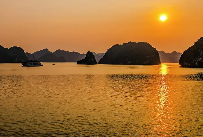 Framed Print : Ha Long Bay, Vietnam. Landscape view of boat carrying tourists at sunset through the limestone karsts and islets of the UNESCO Heritage Site Framed Print : Ha Long Bay, Vietnam. Landscape view of boat carrying tourists at sunset through the limestone karsts and islets of the UNESCO Heritage Site