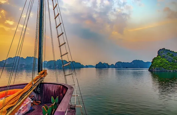 Framed Print : Ha Long Bay, Vietnam. Wide angle landscape view of tourist boat at sunset among the limestone karsts and islets Framed Print : Ha Long Bay, Vietnam. Wide angle landscape view of tourist boat at sunset among the limestone karsts and islets