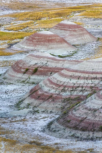 A half circle of rounded mounds or hoodoo, sharply striated with reds