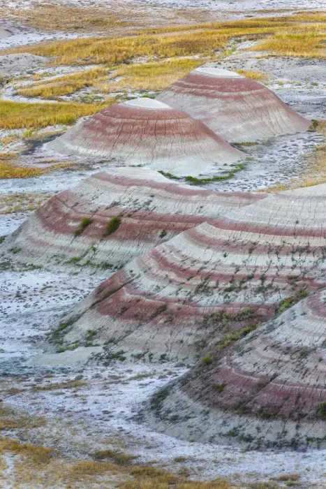 Framed Print : A half circle of rounded mounds or hoodoo, sharply striated with reds Framed Print : A half circle of rounded mounds or hoodoo, sharply striated with reds