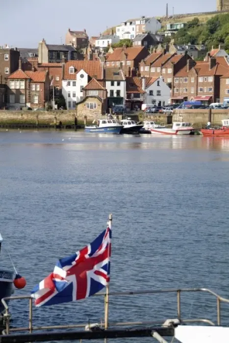 Framed Print : Harbor with fishing boats in the Harbor with Union Jack of beautiful tourist town