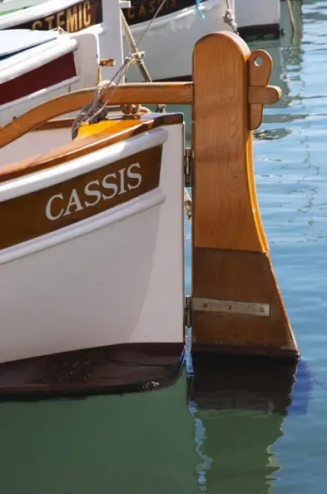 Framed Print : In the harbour in Cassis village. A traditional style boat with wooden rudder marked Framed Print : In the harbour in Cassis village. A traditional style boat with wooden rudder marked