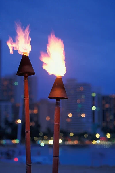 Hawaii Lit torches with skyline in background