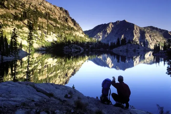 Framed Print : Hiker at sunset overlooking Looking Glass Lake in the Eagle Cap Wilderness, Oregon