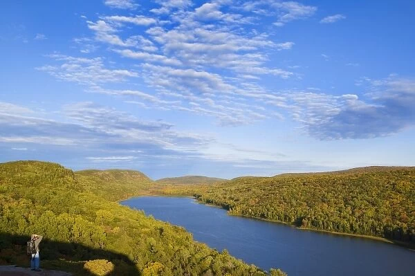 Hiker takes in the view at the Lake of the Clouds in Porcupine Mountains State Park