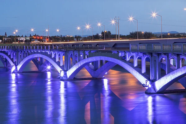 Historic Ninth Street Bridge glows at dusk on the Missouri River in Great Falls, Montana